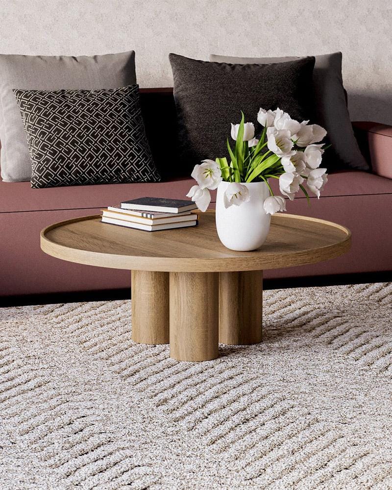 Geometric Japandi round solid oak coffee table with spherical base in a minimalist living room