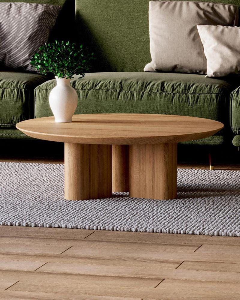 Minimalist round solid oak coffee table with customizable dimensions in a modern interior setting